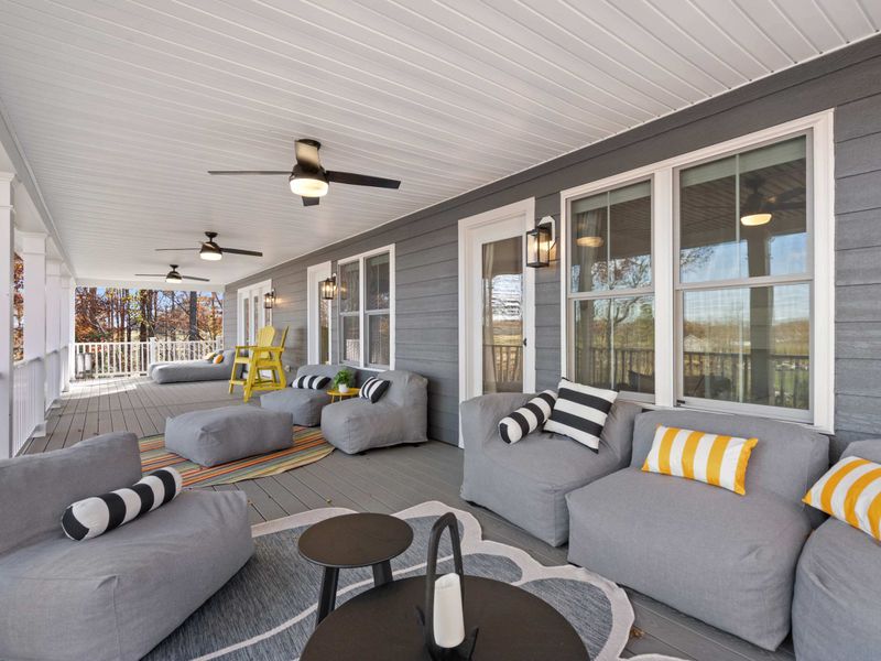 Deck Seating - Striped pillows and oversized loungers line the covered porch, with room for the whole group to spread out.