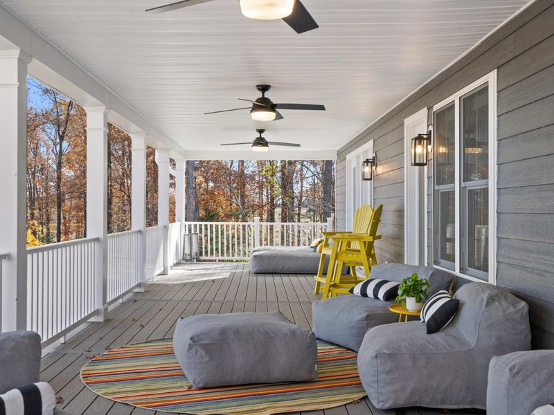 Porch Corner - A cozy reading nook at the end of the wraparound deck, surrounded by fall foliage and fresh air.