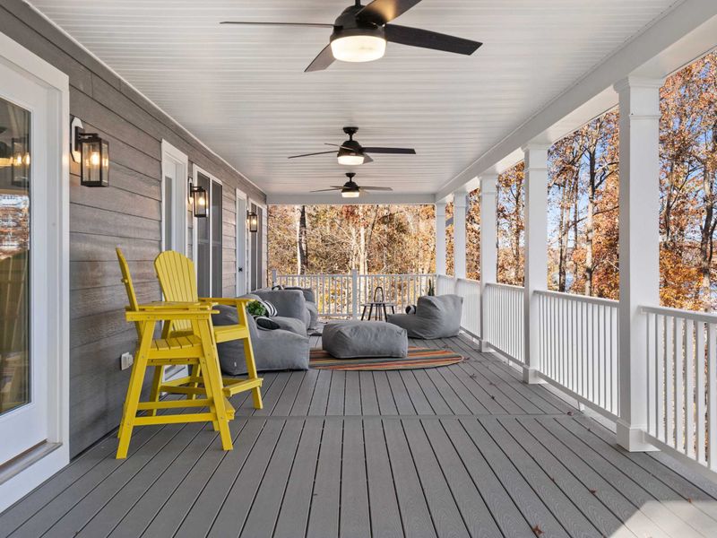 Deck Perspective - Ceiling fans, lantern sconces, and plush seating create an outdoor living room that extends the evening.