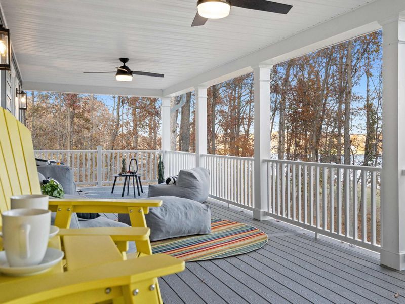 Morning Coffee Spot - Yellow Adirondack chairs and a lounger on the covered upper deck, with coffee cups ready and lake views ahead.