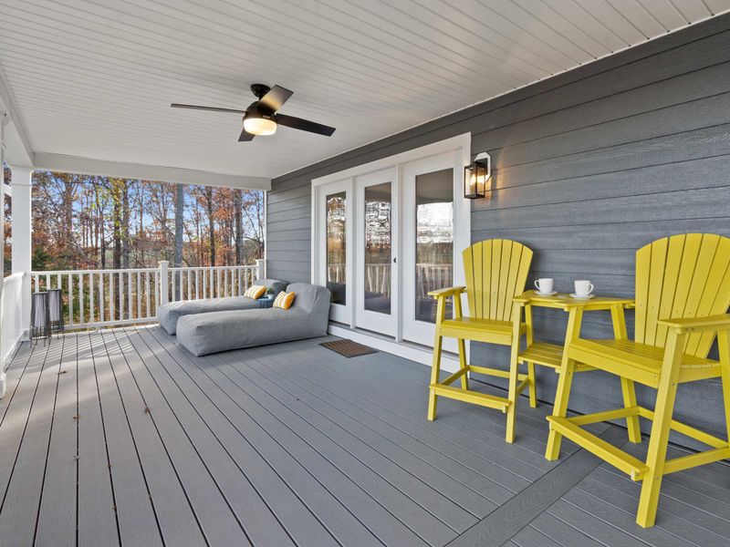 Side Deck - A daybed, yellow Adirondack chairs, and a coffee station create another inviting spot along the covered porch.