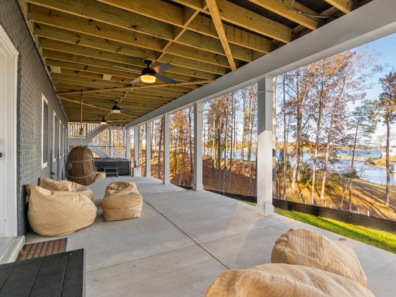 Ground Level Patio - Bean bags, swing chairs, and a view of the lake from the shaded patio beneath the home.