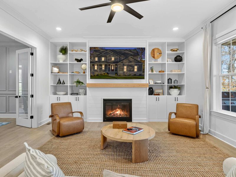 Fireplace Wall - The shiplap surround, oak mantel, and curated shelving frame the 4K Smart TV above the gas fireplace.