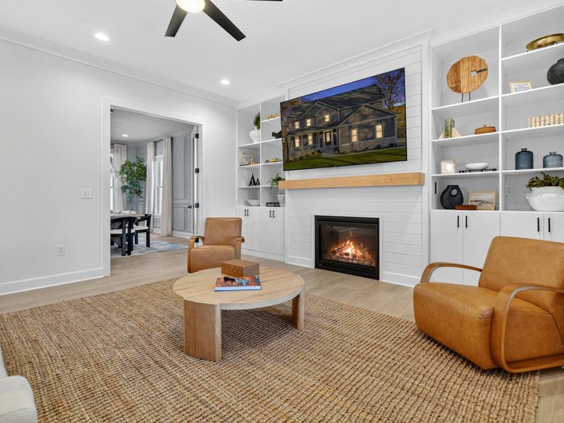 Fireside Seating - Leather club chairs and a round coffee table create an intimate conversation area by the fireplace.