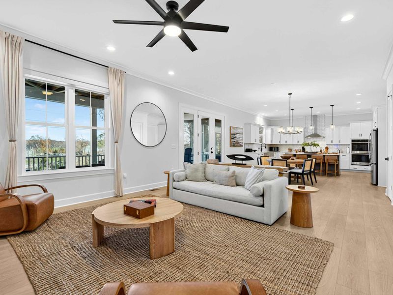 Open Floor Plan - The great room flows into the kitchen and dining area, with light oak floors, high ceilings, and views of the lake.