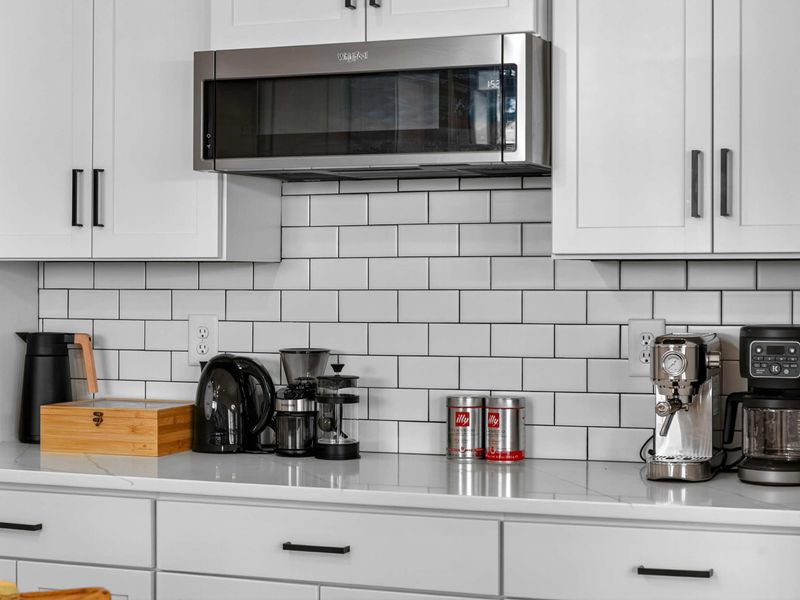 Coffee Station - A full coffee bar with a Keurig, espresso machine, pour-over, and Illy coffee, ready for every kind of morning person.