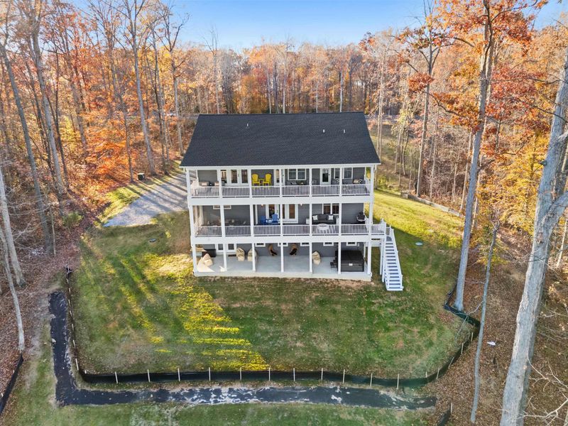 Aerial Lakeside - A bird's-eye view of the home, yard, and shoreline, with the private-side waters of Lake Anna beyond.