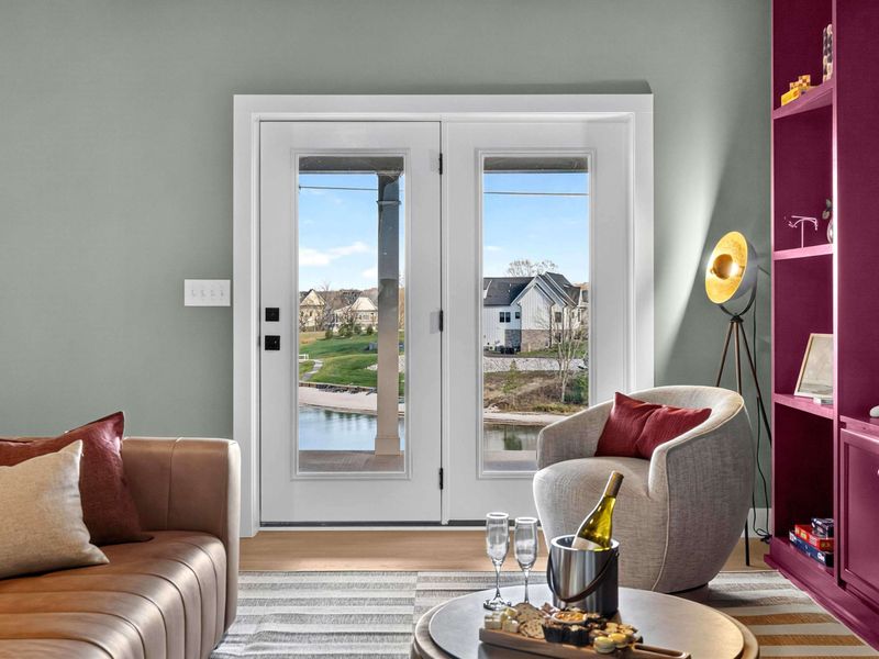 Lounge Lake View - French doors open to the lower patio and lake, with the leather sofa, swivel chair, and champagne ready.