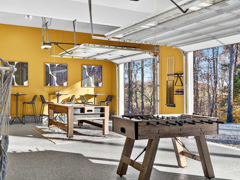 Game Room Open Air - The garage doors open to bring fresh air into the game room, with foosball and the cue rack visible.