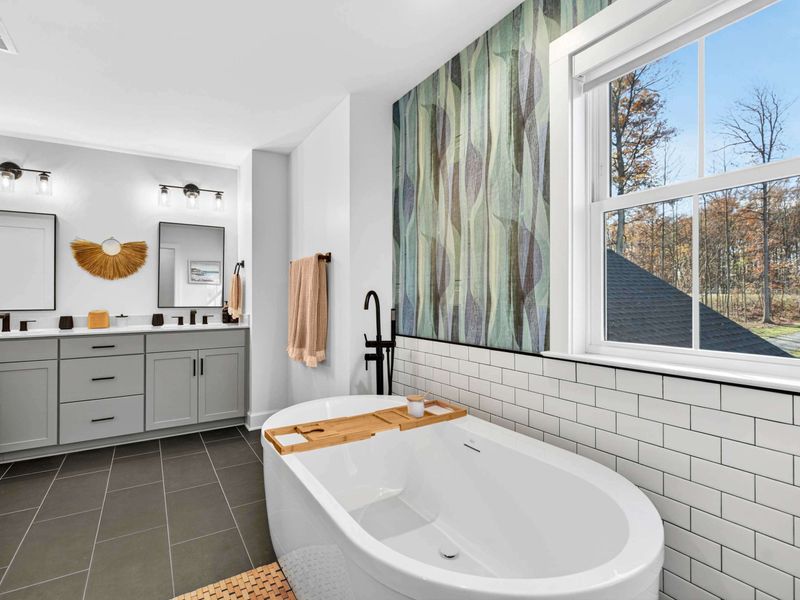 Primary Bath Full View - The freestanding tub, double vanity, and botanical accent wall in the primary ensuite.