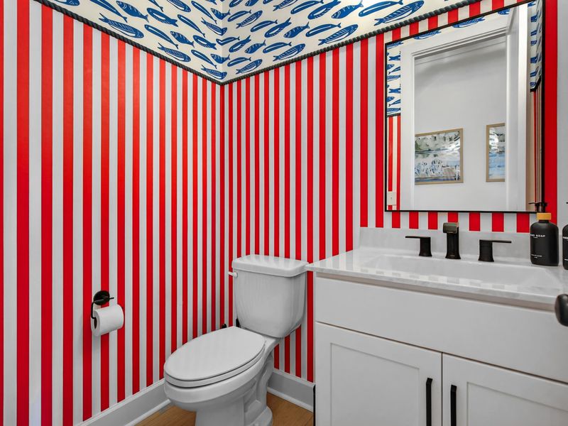 Powder Room - Bold red and white stripes with a fish-print ceiling create a memorable and fun half bath.
