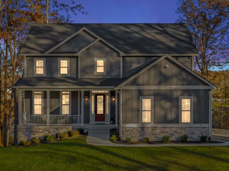 Front Exterior - Craftsman-style curb appeal with a covered porch, stone accents, and warm lighting at dusk.