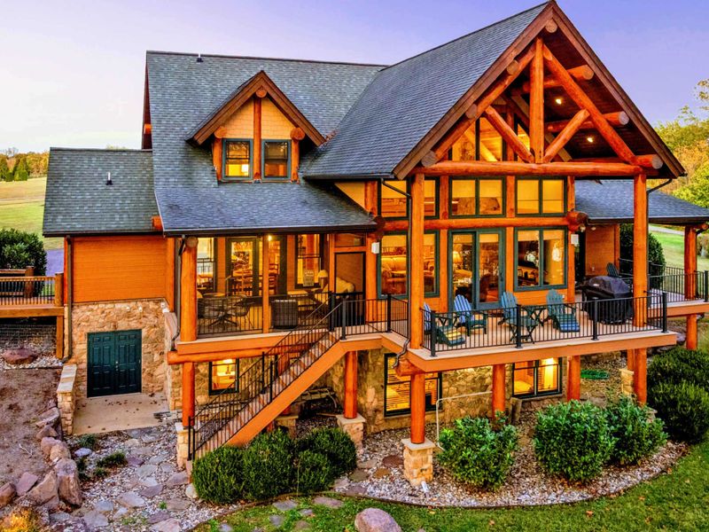 Experience the charm of this luxurious log cabin with stunning architecture, spacious balconies, and breathtaking views of the surrounding nature.