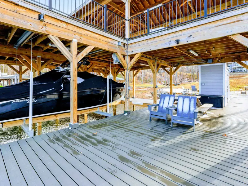 Patio Entrance - The covered patio wraps around the lower level, with a spiral staircase connecting to the upper deck.