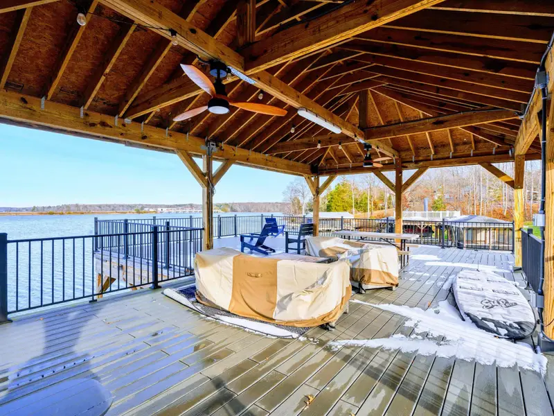 Spiral Staircase - A spiral staircase links the lower patio to the upper balcony, with the dock and lake just beyond.