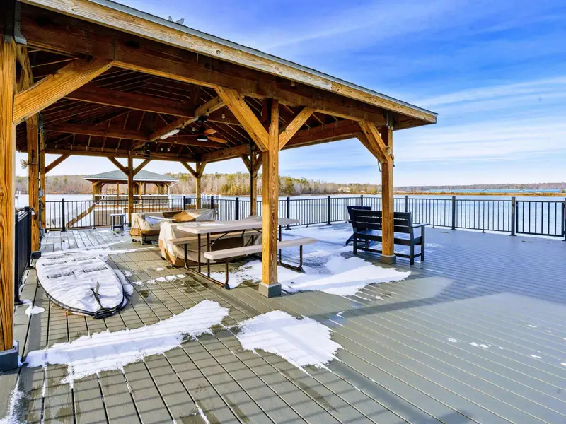 Upper Deck - The expansive upper deck offers a picnic table, Adirondack chairs, and unobstructed lake views under a cedar ceiling.