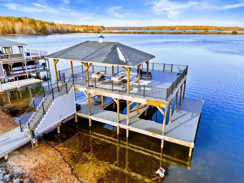 Upper Deck - The side deck wraps around the home with room to relax and enjoy the tree-lined views.
