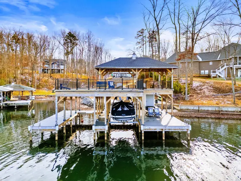 Covered Deck - The peaked wood ceiling and wall of windows create a seamless connection between the great room and the deck.