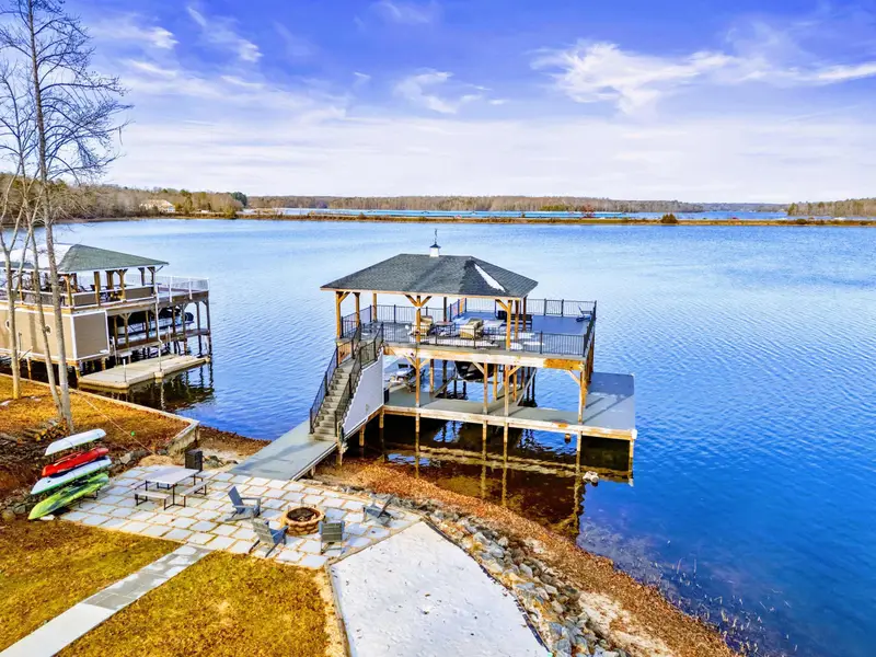 Aerial View - The two-tiered covered dock stretches into Lake Anna, with the estate rising up the hillside behind it.