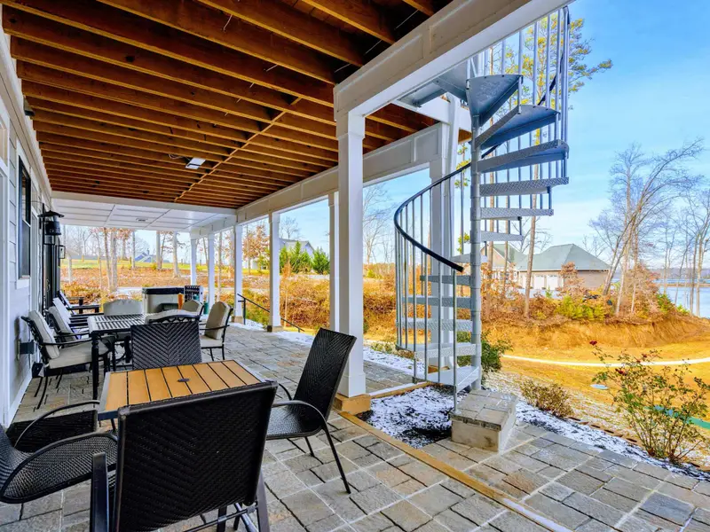 Kitchen Island - Blue cabinetry, quartz countertops, and leather-topped stools line the oversized island, perfect for casual meals or morning coffee.