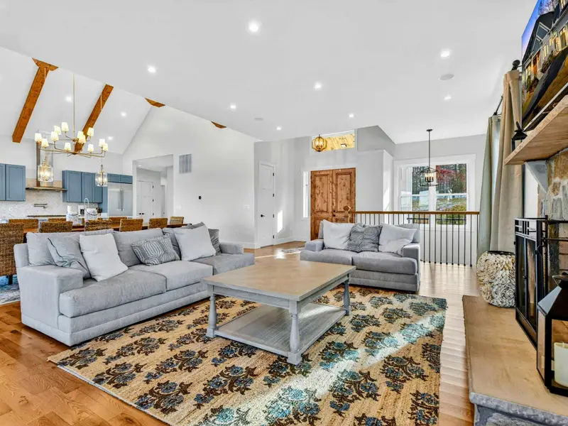 Entry and Great Room - The front entry opens to gleaming hardwood floors, the staircase, and the great room beyond.