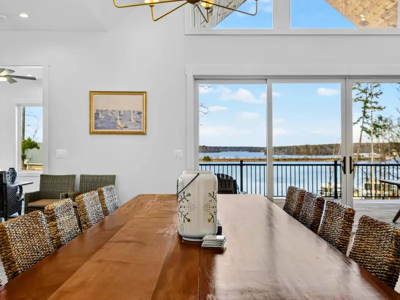 Ping Pong Table - Paddles ready, the Joola table sits in the open game room with the patio doors and spiral staircase nearby.