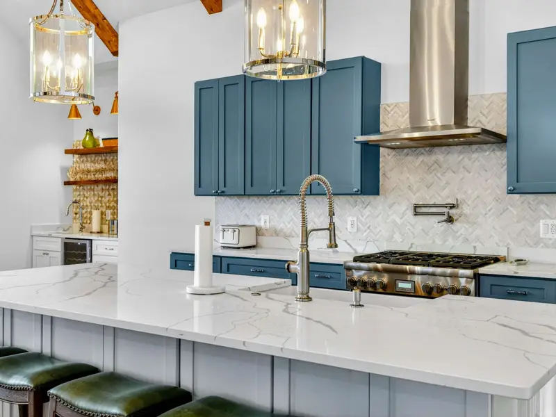 Lower Kitchen - Bistro-style stools line the island in this fully equipped lower-level kitchen, with bedrooms just down the hall.