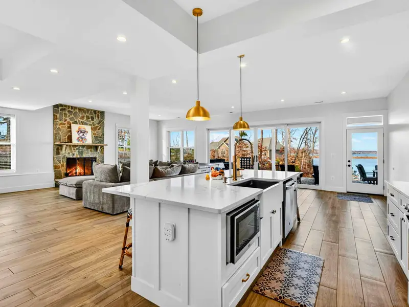 Upper Bedroom 3 - A queen bed with blue bedding, a leather loveseat, and a luggage rack make this a comfortable guest room.