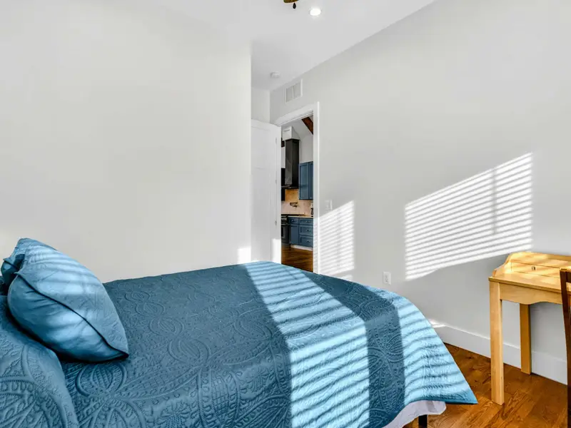 Bunk Room - A wall-mounted TV and striped bedding give this room a fun, camp-style energy that younger guests love.