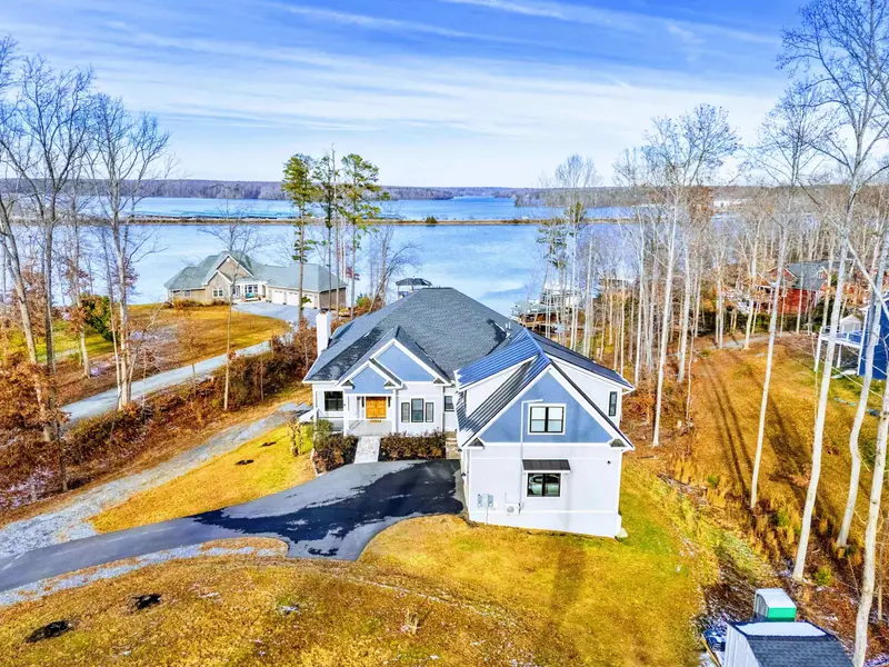 Aerial - Pulling back to show the home nestled among trees on the Lake Anna shoreline.