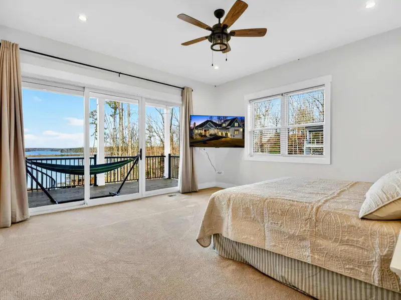 Lower Bedroom 4 - Two queen beds with floral bedding, nightstands, and a wall-mounted TV offer flexible sleeping for groups.