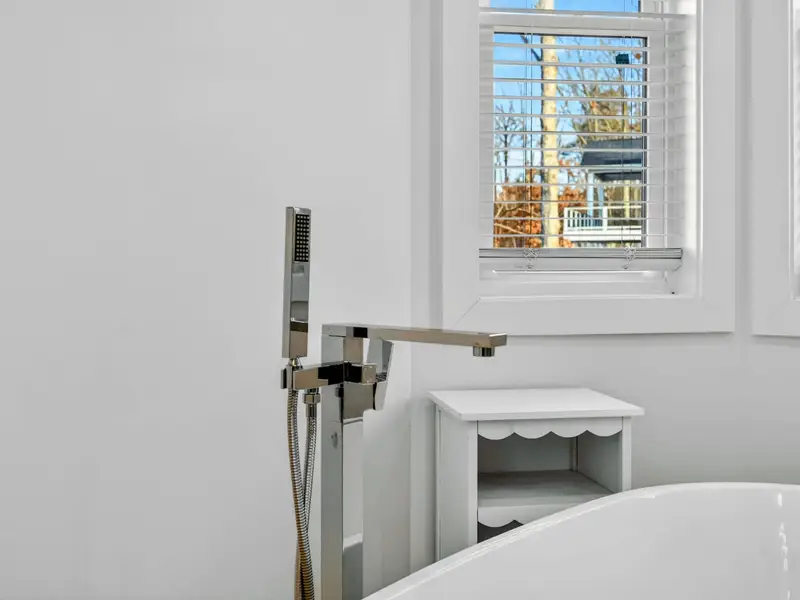 Bedding Detail - Neutral tones and a dark upholstered headboard bring a modern, restful feel to the lower bedroom.