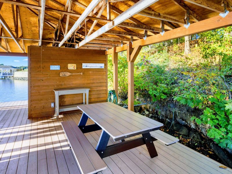 Dock - Covered picnic table on the dock provides a shady spot for lakeside lunches surrounded by greenery.
