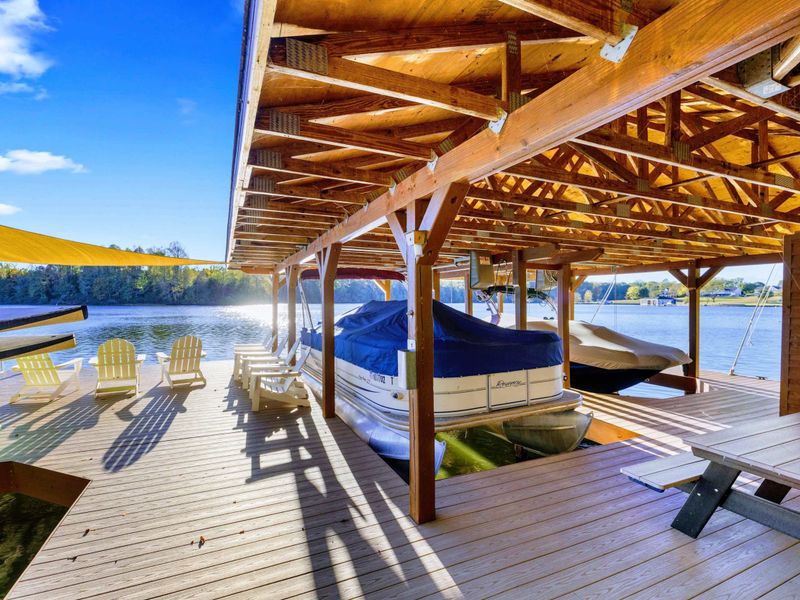 Boathouse - Timber frame covered boathouse shelters the boat and creates a shaded gathering spot on the water.