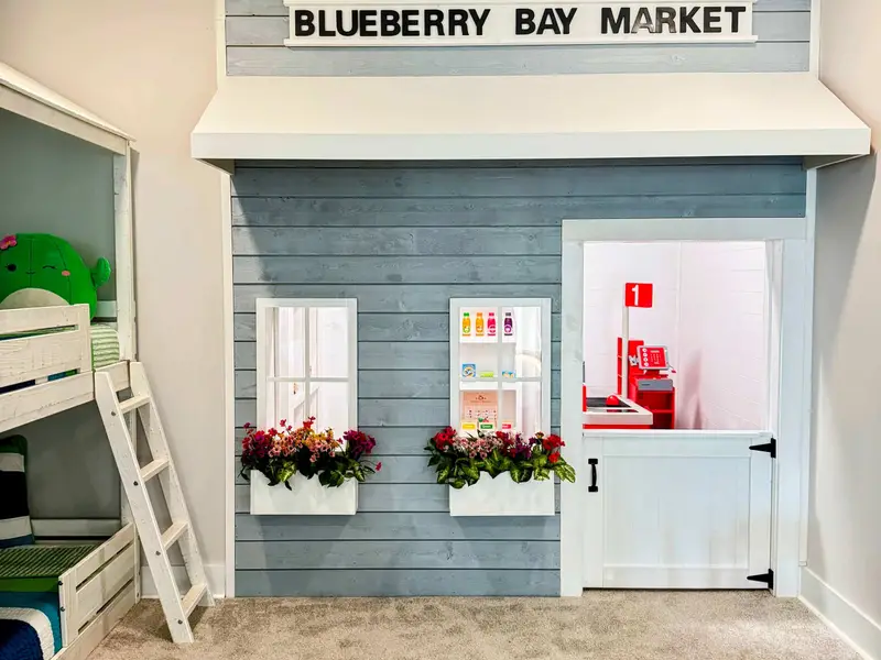 Blueberry Bay Market - A custom-built playhouse storefront with shiplap siding, window boxes with flowers, and a full play store inside for kids of all ages! It even has a working doorbell and play phone!  Guests say kids don't want to leave!