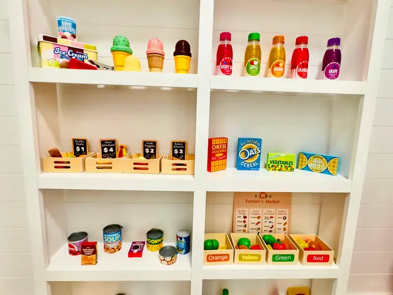 Market Shelves - Inside the Blueberry Bay Market, shelves are stocked with play groceries, ice cream, and produce for hours of imaginative play.
