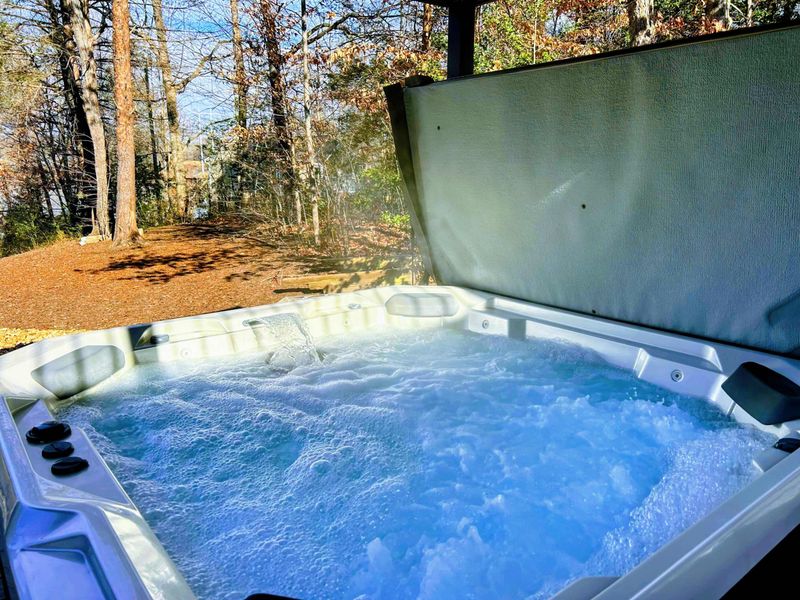 Hot Tub - Bubbling spa close-up surrounded by fall foliage for a relaxing soak any season.