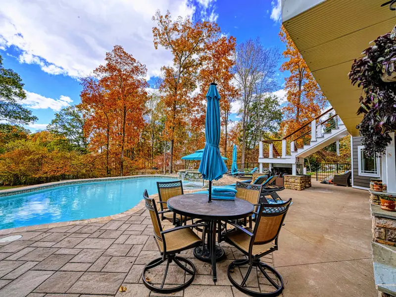 Expansive upper deck + lower patio with multiple seating zones for sunning, reading, and long late-night conversations.