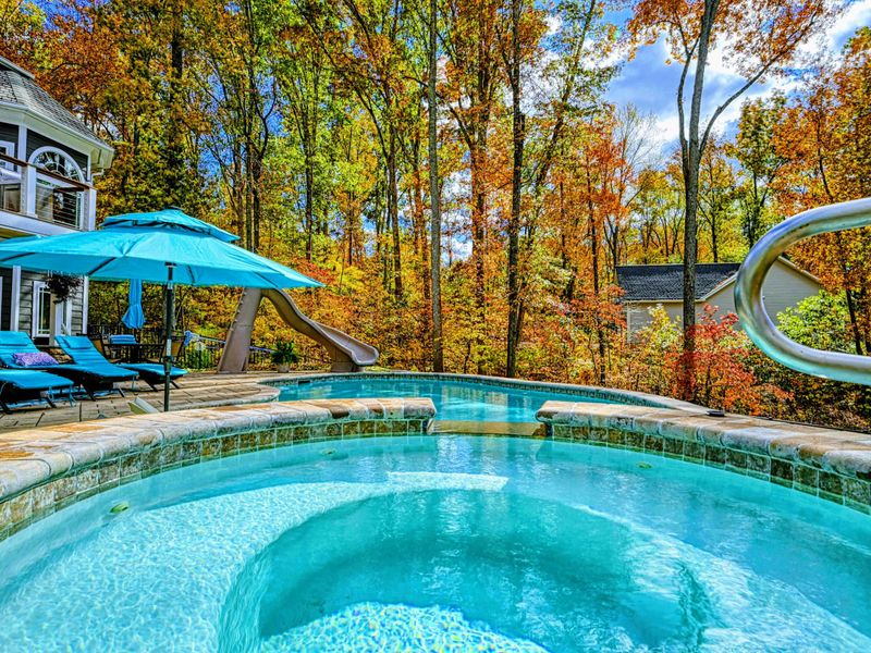 Oversized umbrellas & luxe outdoor furniture in matching lake-blue tones.