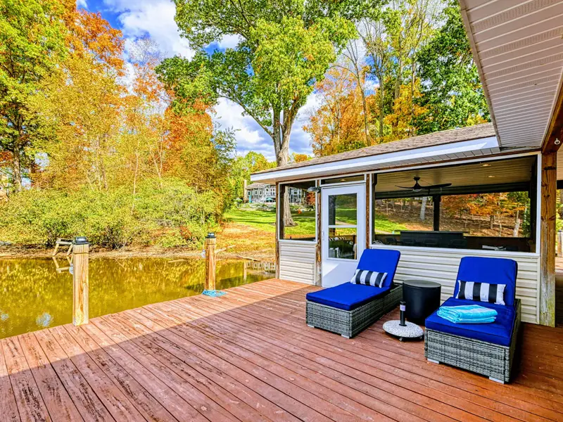Sun deck with loungers, umbrella & side-table coolers to keep drinks chilled.