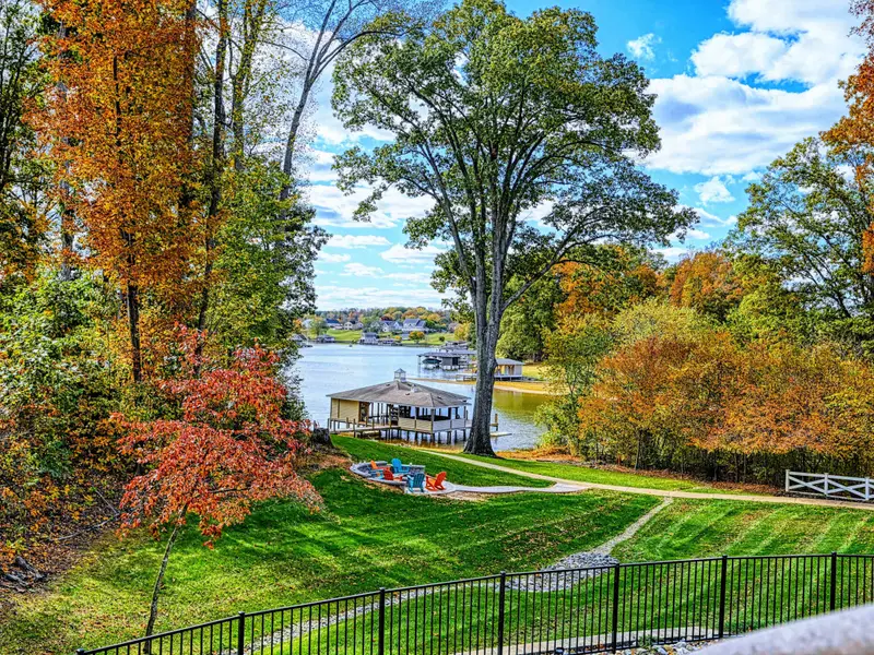 Professionally manicured lawn with dramatic stripes, sculpted gardens, and curated pathways.