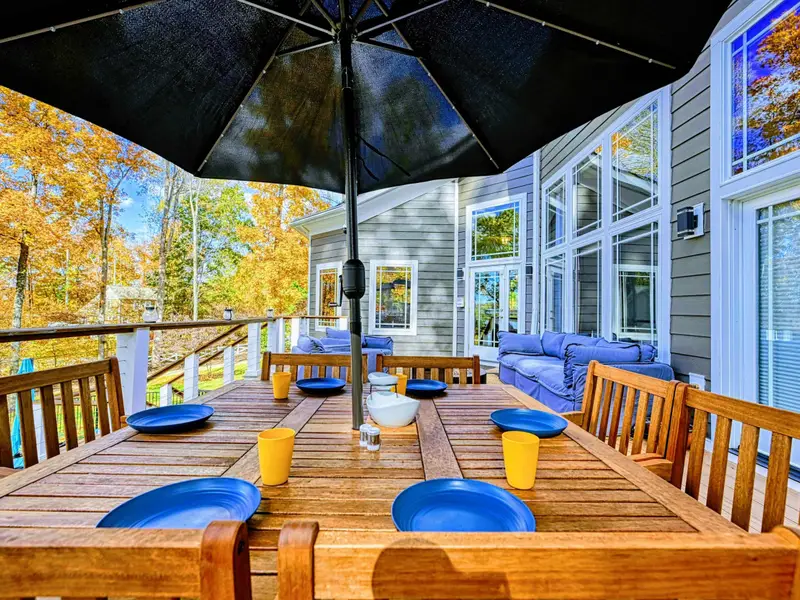 Dine with a view at a beautiful farm-style teak table for eight, complete with an oversized umbrella for sunny afternoons and a refreshing lake breeze to elevate every meal.