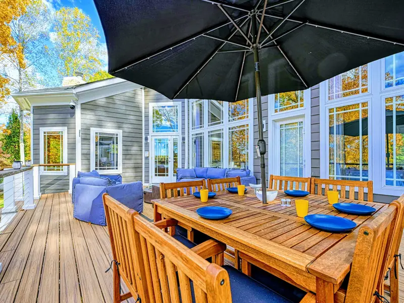 Dine with a view at a beautiful farm-style teak table for eight, complete with an oversized umbrella for sunny afternoons and a refreshing lake breeze to elevate every meal.