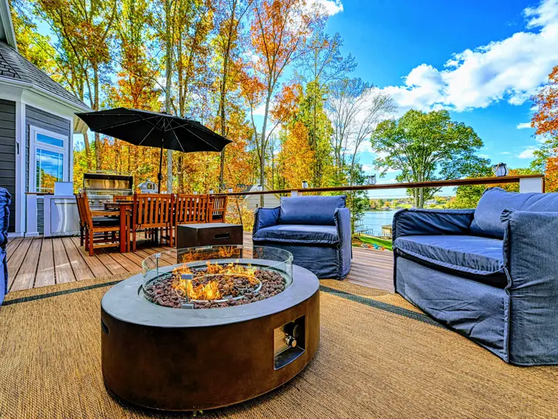 Expansive upper deck + lower patio with multiple seating zones for sunning, reading, and long late-night conversations.