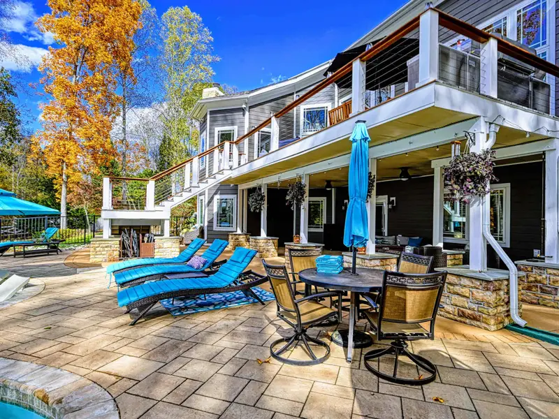 Expansive upper deck + lower patio with multiple seating zones for sunning, reading, and long late-night conversations.