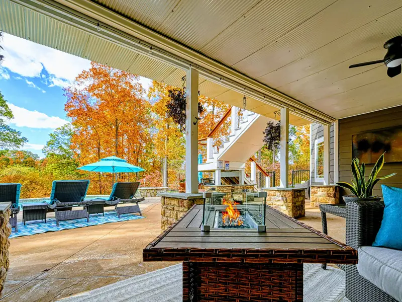 Expansive upper deck + lower patio with multiple seating zones for sunning, reading, and long late-night conversations.