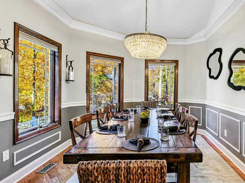 The formal dining room seats eight comfortably, filled with natural light, lake views, and chandelier glow—elegant enough for celebrations, relaxed enough for barefoot breakfasts and long, laughter-filled evenings.