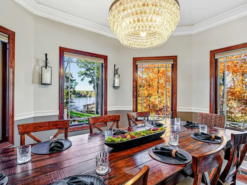 The formal dining room seats eight comfortably, filled with natural light, lake views, and chandelier glow—elegant enough for celebrations, relaxed enough for barefoot breakfasts and long, laughter-filled evenings.