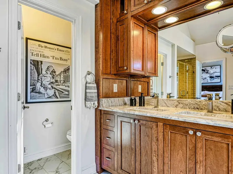 The Primary Ensuite is a spa-like retreat featuring a soaking tub with lake views, arched windows, and an oversized walk-in shower with dual heads and bench—designed for quiet mornings, slow evenings, and total relaxation.