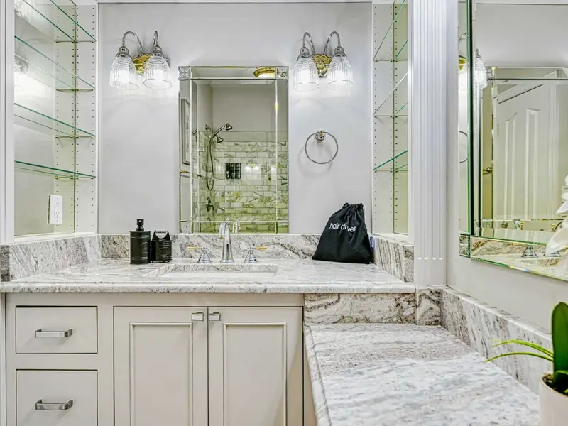 The Junior Primary Ensuite is a chic, spa-like bath with marble tile, refined lighting, and a fully tiled walk-in shower with excellent water pressure—bringing boutique-hotel elegance and quiet luxury to this private retreat.